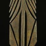 Photo of a Tiwi island spear carving on a black background