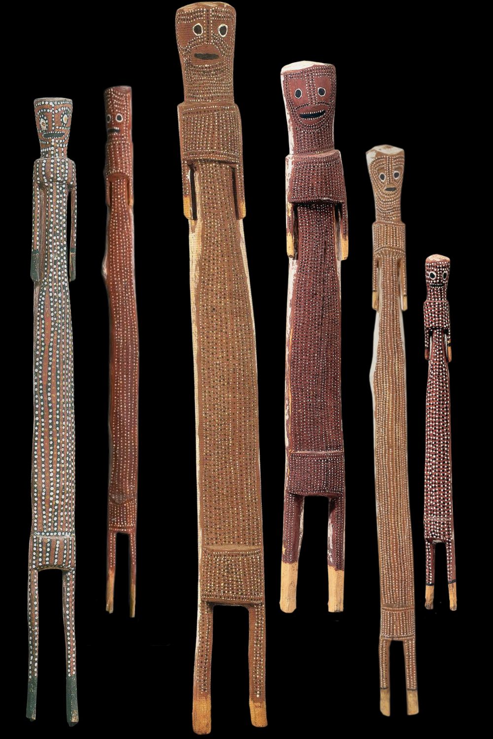 Crusoe Kuningbal Mimih spirit sculptures – distinctive Aboriginal painted wood carvings from Arnhem Land featuring elongated forms, dotted ochre designs, and stylised facial expressions, showcasing the iconic style of pioneering Kuninjku artist Crusoe Kuningbal