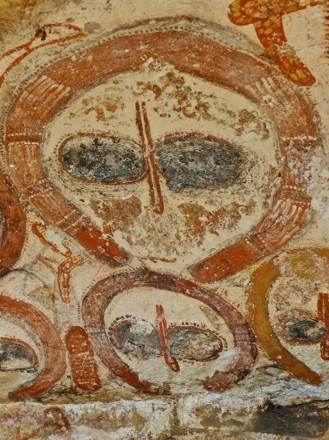 Wandjina painted of a rock wall in the kimberleys photo of Wandjina faces painted of a rock wall in the kimberleys