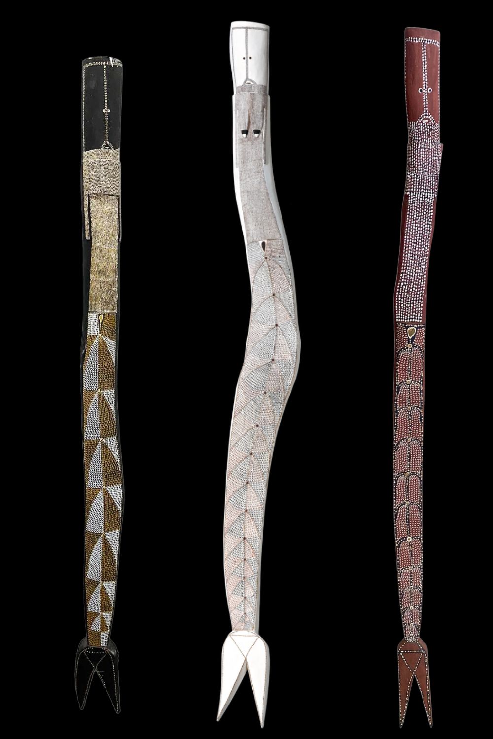 Three carved and painted Yawkyawk sculptures by Owen Yalanda