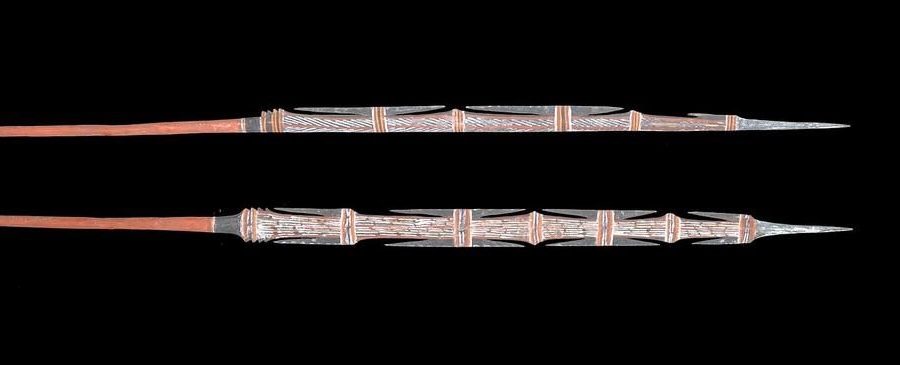 Traditional Groote Eylandt ceremonial spears decorated with Anindilyakwa ochre designs and carved barbed spearheads