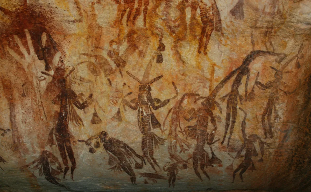 Ancient Gwion Gwion figures painted in ochre on a Kimberley cave wall in Western Australia