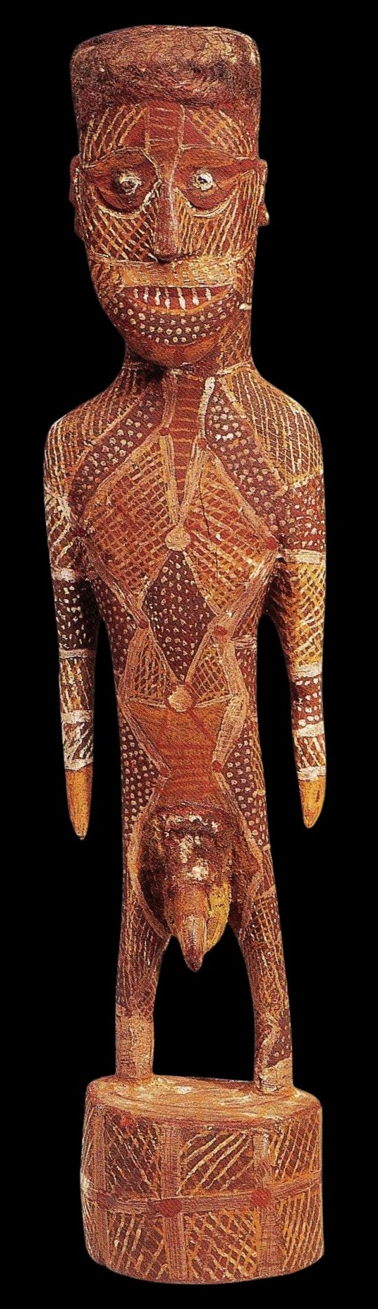Early Tiwi ceremonial sculpture by Cardo Kerinauia depicting an ancestral male figure with painted jilamara designs