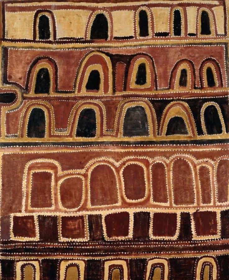 Early East Kimberley ochre painting by Paddy Jaminji depicting ceremonial landscape forms and cave-like ancestral imagery in red, black, and white ochres.
