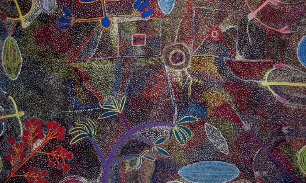 Painting by Ada Bird Petyarre featuring intricate dot fields, stylised plant forms, and ceremonial motifs representing Bush Yam Dreaming and the interconnected ecology of Country.
