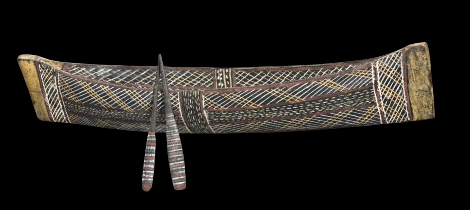 Traditional Groote Eylandt carved canoe sculpture decorated with Anindilyakwa ceremonial designs and crosshatched ochre patterns