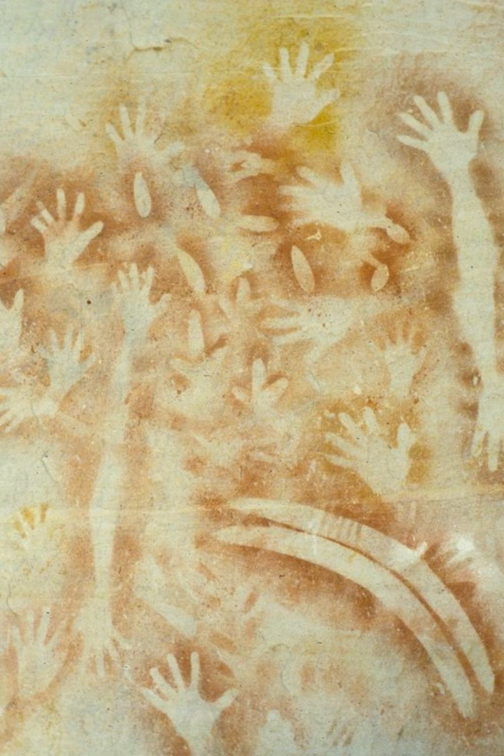 Aboriginal hand stencil rock art in Carnarvon Gorge created using ochre pigment sprayed over hands against a sandstone cave wall