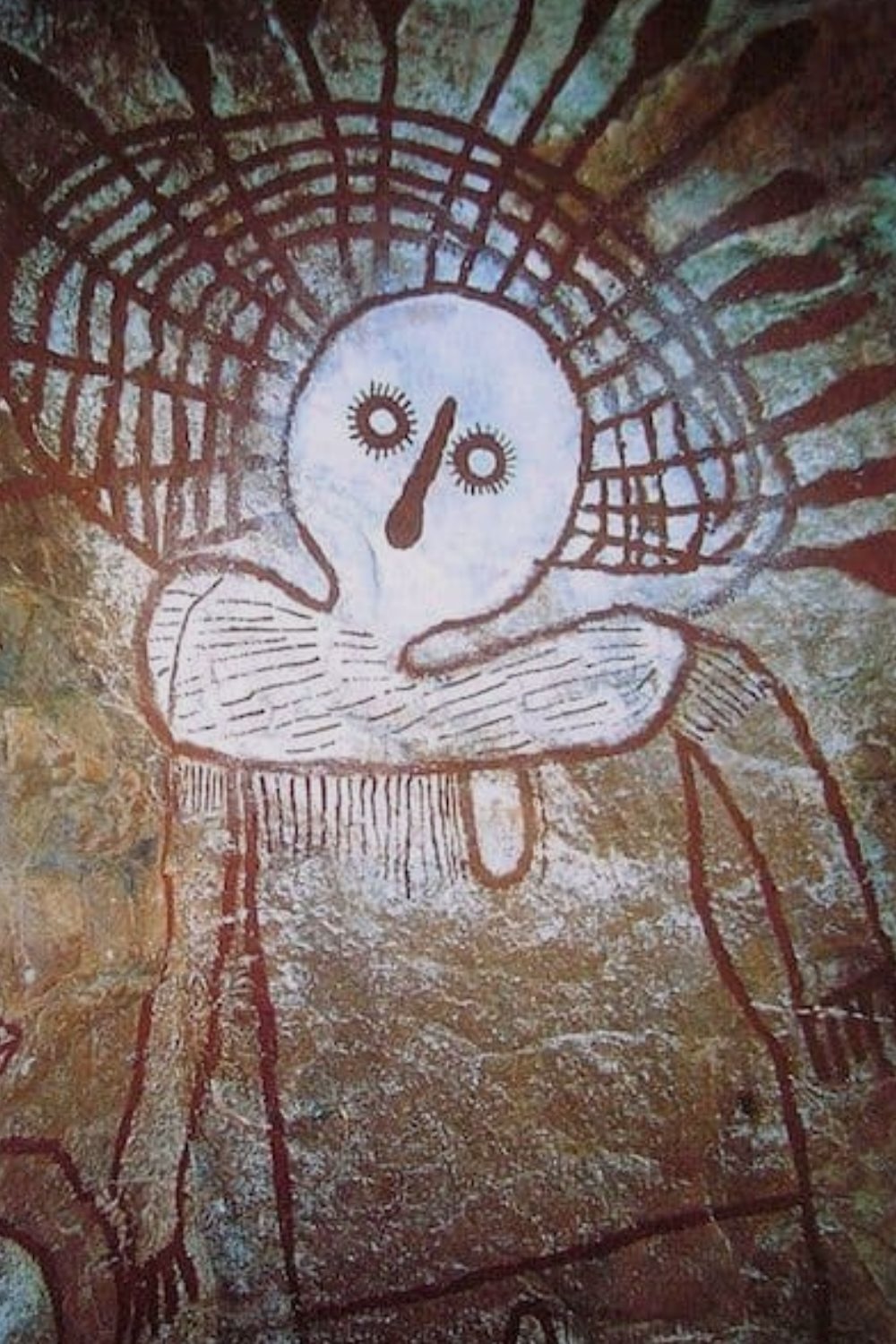 Large Wandjina ancestor figure painted in white and red ochre on a Kimberley rock shelter wall in Western Australia
