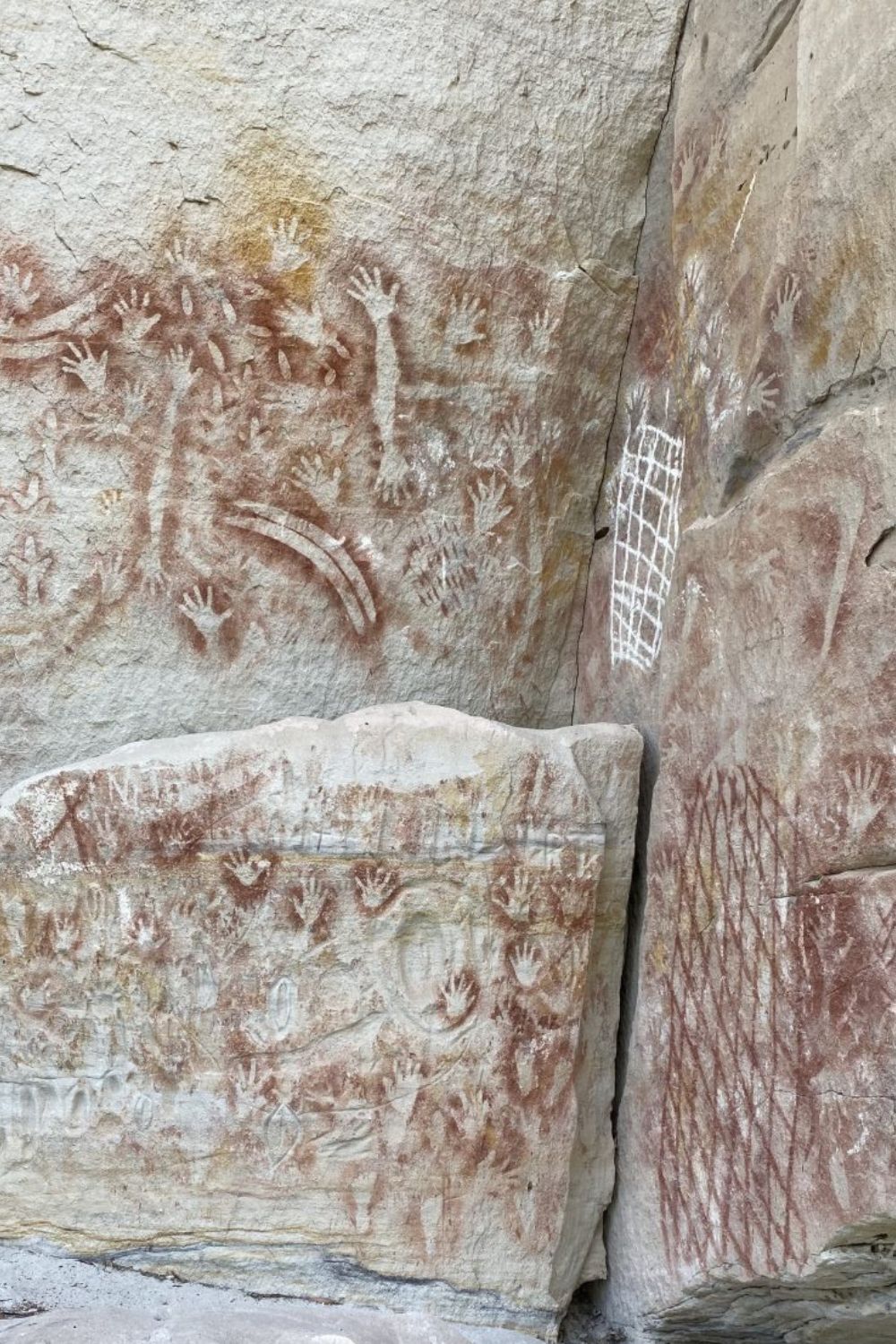 Aboriginal hand stencils and geometric net motifs at Carnarvon Gorge rock art site in Queensland