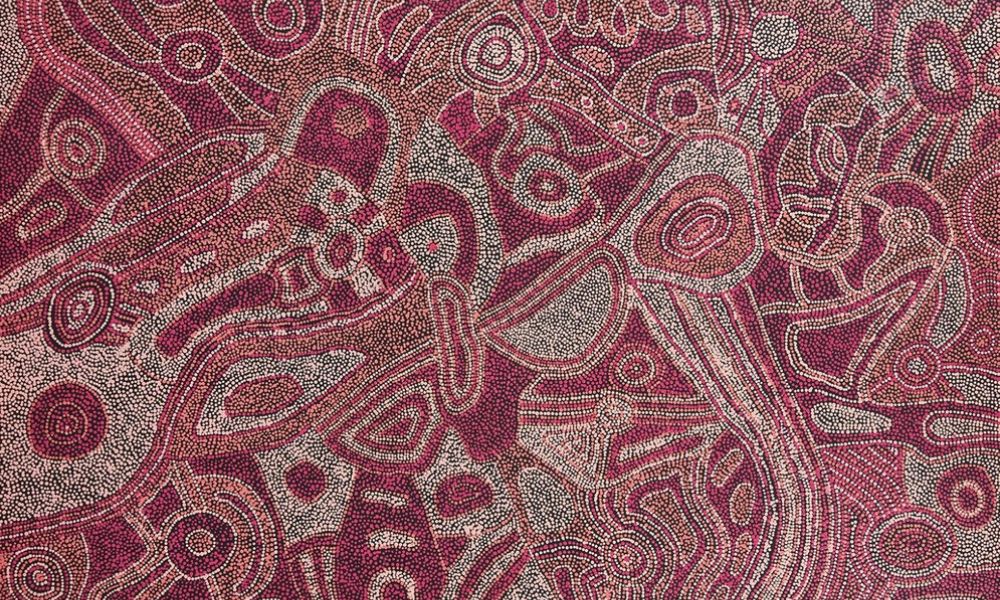 Painting by Betty Kuntiwa Pumani featuring intricate fields of red, pink, and white dotting depicting Antara Country, sacred sites, and Maku Tjukurpa in the APY Lands.
