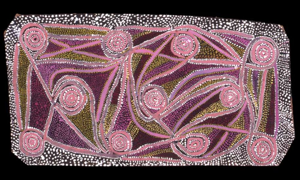 Early Papunya painting by Uta Uta Tjangala featuring concentric circles, flowing ceremonial pathways, and dotted Western Desert imagery