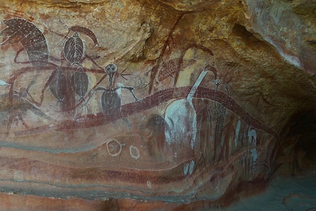 Ancient Quinkan rock painting depicting spirit figures, ceremonial imagery, and stylised animal forms in a Cape York sandstone shelter