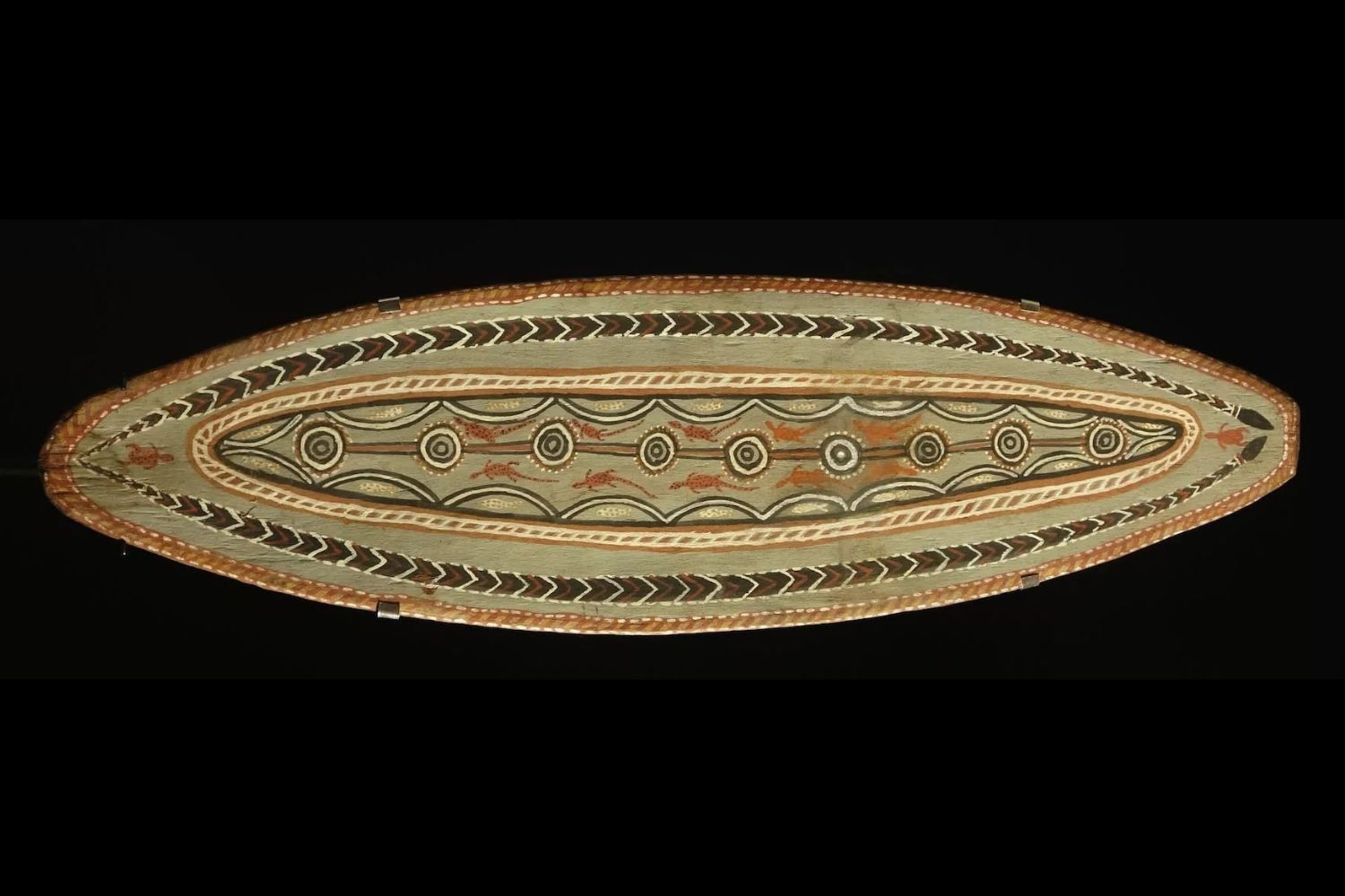 Early Port Keats bark painting by Indji Tharwal featuring ceremonial symbolic imagery and concentric ochre designs on elongated eucalyptus bark