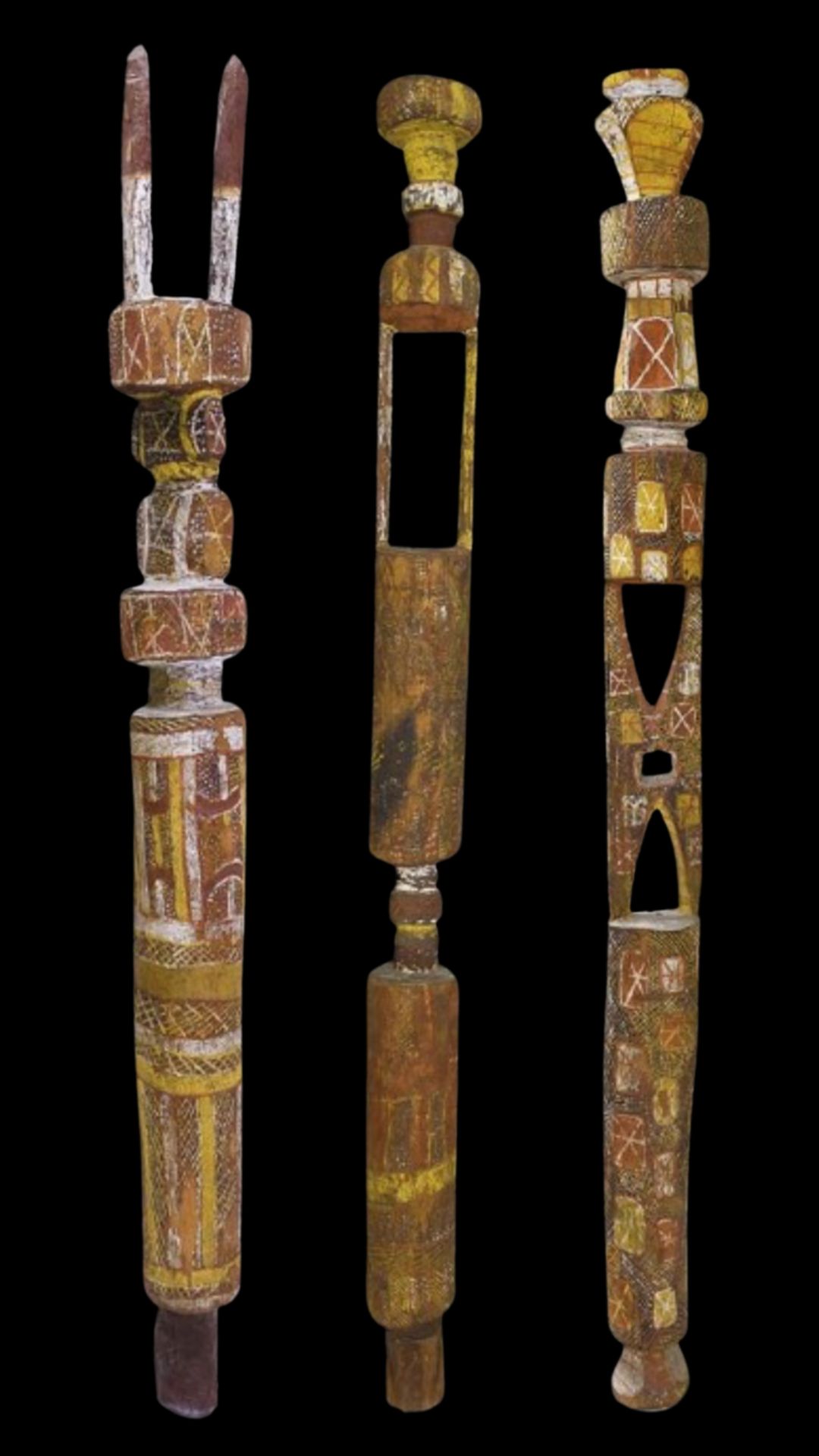 Traditional Tiwi Art tutini Pukumani poles painted with jilamara ceremonial designs from the Tiwi Islands