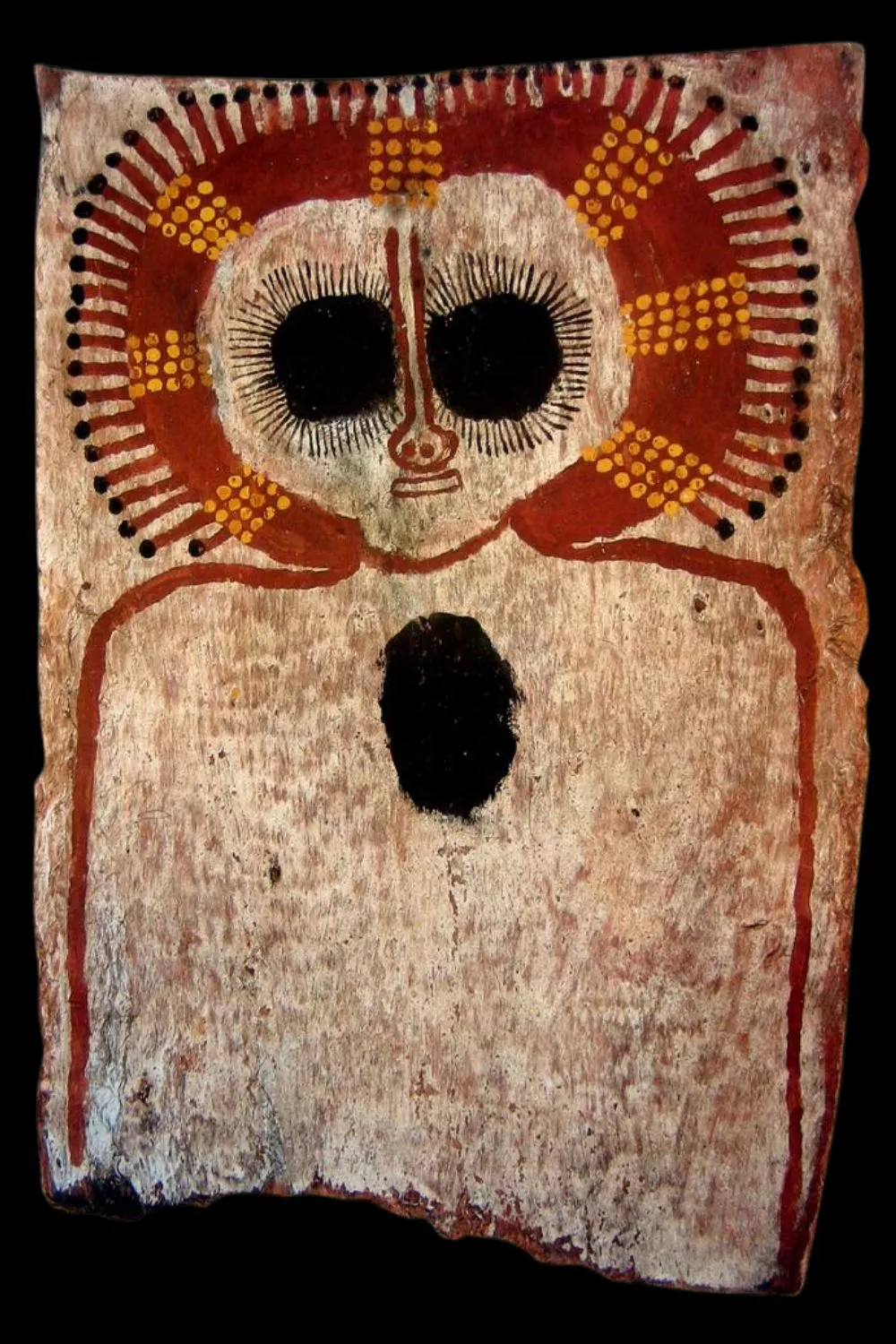Traditional Kimberley bark painting depicting a Wandjina ancestral spirit with large black eyes, halo-like headdress, and mouthless face.