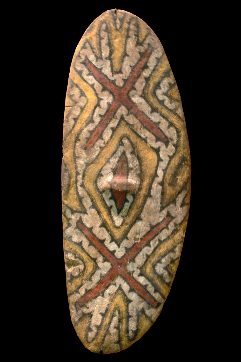 Traditional Aboriginal shield decorated with ochre geometric designs, representing one of Australia's oldest surviving artistic traditions.