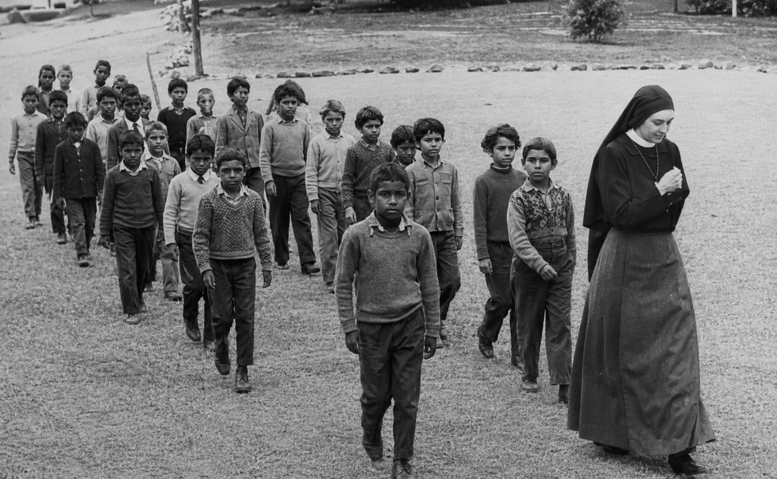 Noongar children walking in formation at the Carrolup Native Settlement in Western Australia during the mid-twentieth century.