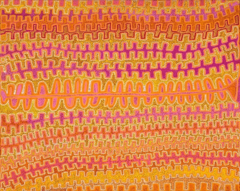A wide horizontal Aboriginal painting in radiant shades of magenta, hot pink, burnt orange, golden yellow, ochre, cream and white. The surface is filled with closely spaced horizontal bands of repeating stepped patterns built from thousands of tiny dots, creating the appearance of endless parallel sand ridges stretching across the desert. A bold pale orange and white pathway runs across the centre of the painting from left to right, looping in a continuous wave before narrowing at the far right edge. The surrounding bands alternate between bright pink, orange and yellow, producing a shimmering optical effect as the colours vibrate against one another. The repeated horizontal rhythms give the painting a powerful sense of movement, like an aerial view of sunlit sandhills crossed by an ancestral travelling route.