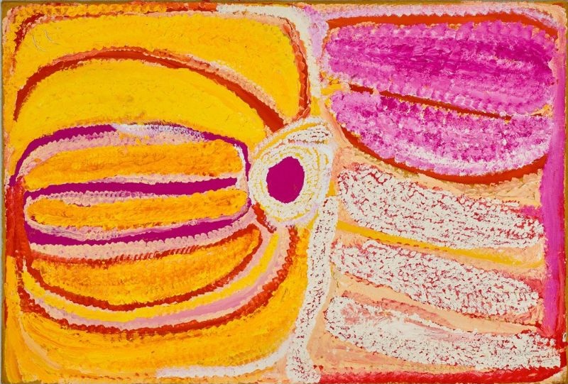Kinyu by Eubena Nampitjin showing a bright pink central rockhole, golden yellow sandhill forms and white dotted contours in the Balgo painting style.