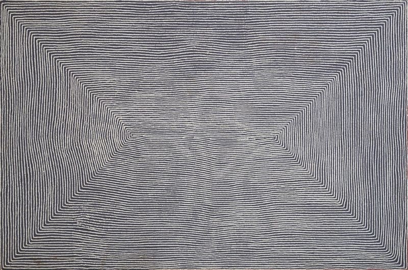 Wilkinkarra (Lake Mackay) by Warlimpirrnga Tjapaltjarri, 2004. A monumental horizontal painting in black, white and soft grey. Thousands of tiny white dots form perfectly aligned horizontal bands that sweep across the canvas. The lines converge from each corner towards a narrow opening at the centre, creating two immense triangular forms and a powerful illusion of depth, like looking across an endless salt lake or desert plain shimmering in the heat.
