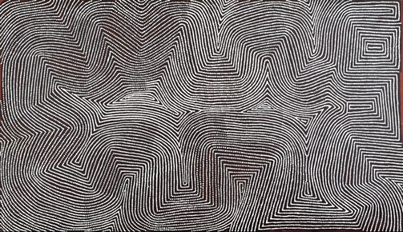 Tingari Site West of Wilkinkarra (Lake Mackay) by Warlimpirrnga Tjapaltjarri, c.2010. A large abstract Aboriginal painting in black, charcoal grey and white. Thousands of tiny white dots form continuous parallel lines that sweep across the canvas in broad curves, sharp zigzags and stepped geometric pathways. The intricate network creates interlocking angular forms and flowing corridors that resemble an aerial view of desert sandhills, ceremonial routes and ancient tracks. The high contrast between the bright white dots and the dark background creates a striking shimmering optical effect.