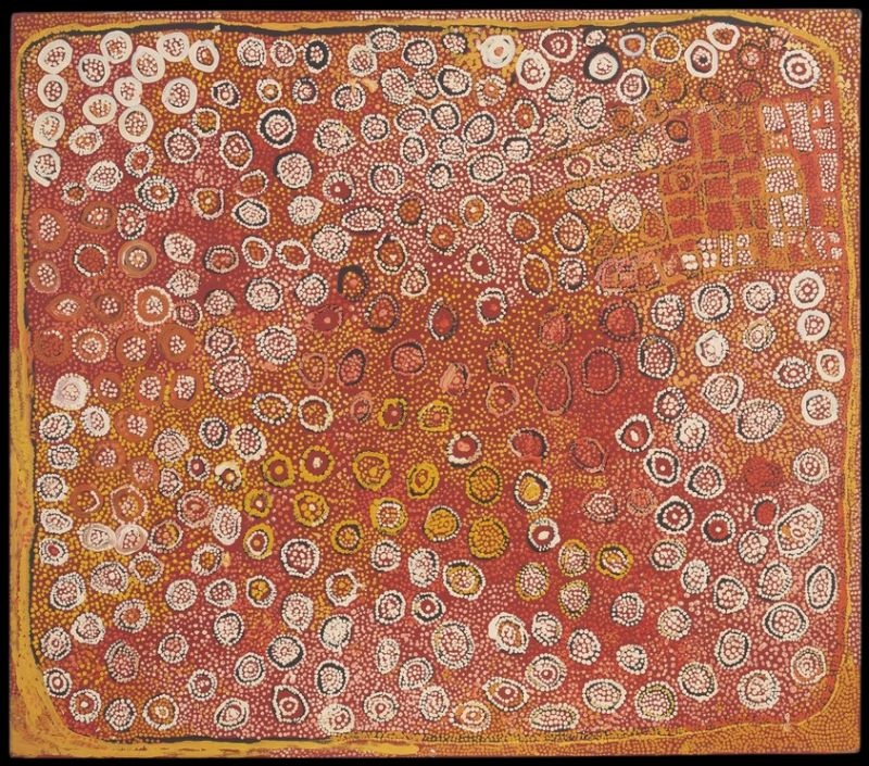 Naata Nungurrayi painting Untitled (Designs Associated with the Rockhole and Soakage Water Site of Ngaminya) (2006), depicting the Ngaminya rockhole and surrounding sandhills in her distinctive flowing Western Desert style.
