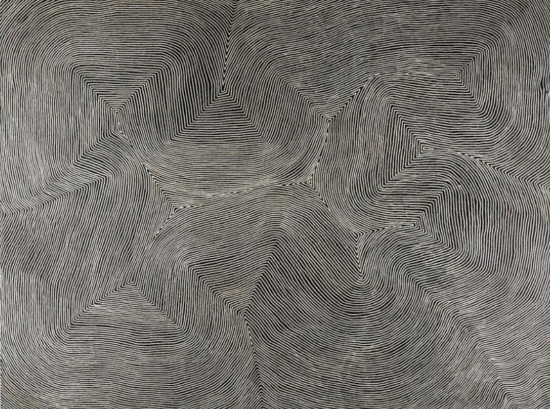 Mamultjunkunya by Warlimpirrnga Tjapaltjarri, 2009. A monumental abstract Aboriginal painting in black, charcoal grey and white. Thousands of fine white parallel lines flow continuously across the dark surface, bending into broad sweeping curves, sharp angular turns and geometric pathways that interlock across the canvas. The tightly controlled linework creates a striking optical shimmer, suggesting an aerial view of desert landforms, ancient travel routes and shifting sandhills.