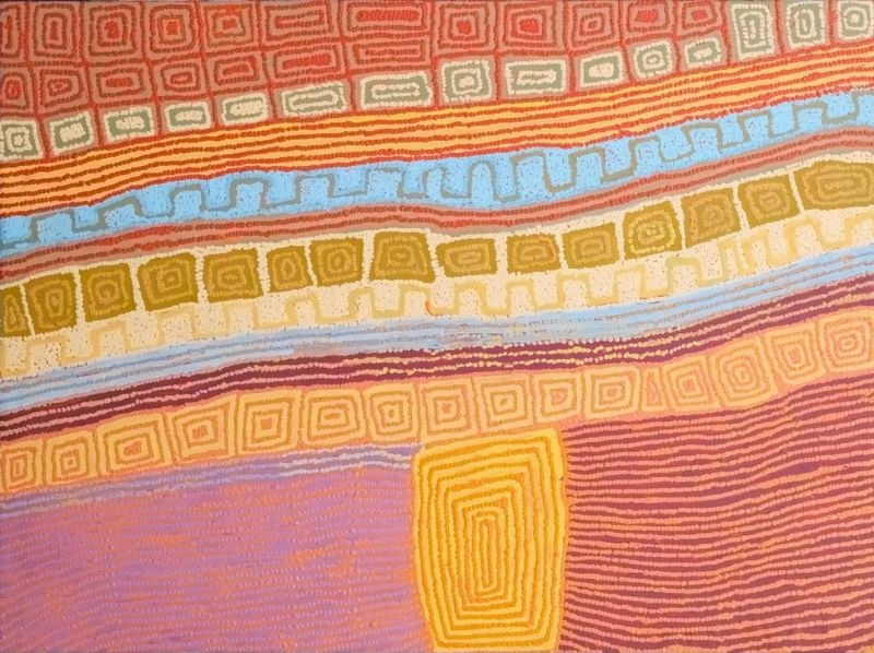 A horizontal Aboriginal painting in soft desert colours of terracotta, burnt orange, golden yellow, cream, pale blue, olive green, mauve and dusty pink. Broad horizontal bands sweep gently across the upper half of the painting, each decorated with repeating concentric rectangular motifs, stepped geometric patterns and finely dotted contour lines. A striking pale blue band runs diagonally across the centre, contrasting with the surrounding warm earth tones. Below, large fields of mauve and dusty pink are divided by a tall golden-yellow rectangular form filled with nested concentric rectangles, creating a strong focal point. Thousands of tiny dots build every line and colour transition, producing a subtle shimmering surface that evokes an aerial view of Country structured by ceremonial pathways and significant places.