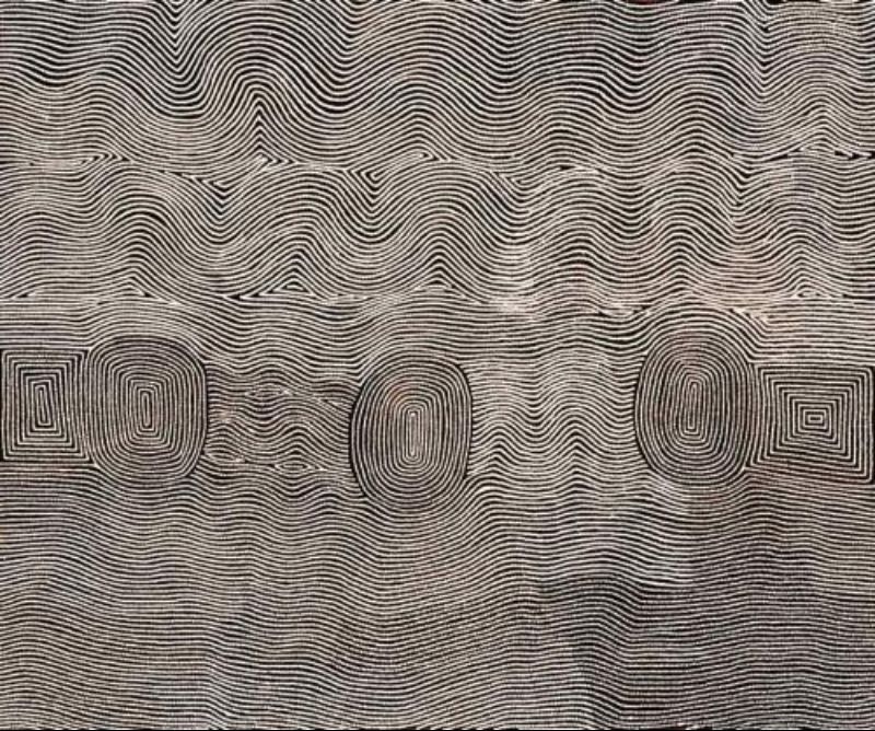 Tingari Men Camped at Marawa, West of Lake Mackay by Warlimpirrnga Tjapaltjarri, 2002. A large horizontal painting in black and white with subtle grey tones. Thousands of fine white dotted lines ripple across a dark background in broad horizontal bands. Four elongated oval and rectangular ceremonial motifs emerge from the flowing lines near the centre, while the entire surface shimmers like wind-blown sand, rippling water or heat haze across the desert.