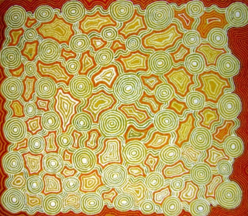 A rectangular Aboriginal painting filled with dozens of pale green concentric circles scattered across a glowing background of golden yellow, bright orange and deep red. The circles vary in size and are connected by soft green pathways that weave through the composition like tracks across the desert. Between them are irregular angular landforms outlined with repeating green and white contour lines, creating a dense network of interconnected shapes. A broad border of rich red frames the painting on all four sides, making the luminous yellow and green centre appear to glow. Thousands of carefully placed dots form every line, producing a vibrant, shimmering surface that resembles an aerial view of ceremonial sites linked across the Western Desert.
