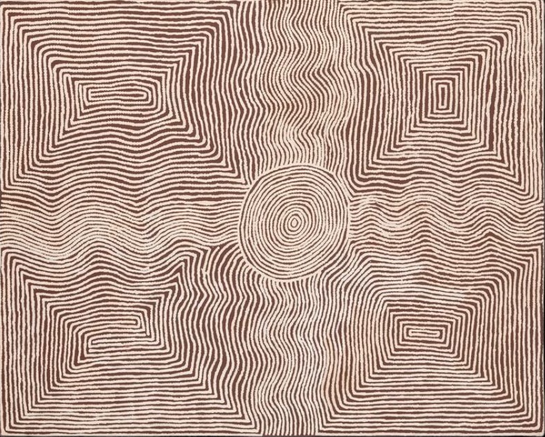Untitled by Warlimpirrnga Tjapaltjarri, 2002. A large horizontal painting in warm reddish-brown and cream. Fine white dotted lines ripple across the canvas, forming four large stepped rectangular motifs in the corners and a single concentric circle at the centre. The flowing lines weave around these ceremonial symbols, creating a shimmering pattern that resembles wind moving across sand or water flowing through the desert.