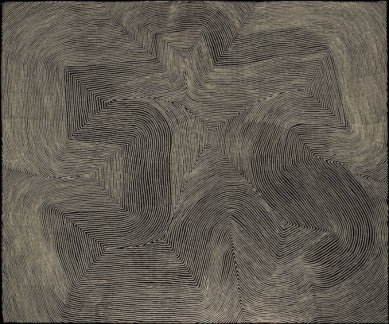 Marawa by Warlimpirrnga Tjapaltjarri, 2012. A monumental abstract Aboriginal painting in black, charcoal grey and white. Thousands of finely painted white parallel lines sweep across the dark surface in broad curves, sharp angular turns and stepped geometric pathways. The flowing lines converge around a small central diamond-shaped motif before expanding outward again, creating a powerful sense of movement, depth and optical shimmer reminiscent of desert sandhills and ancestral pathways seen from above.