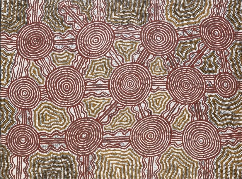 Water Dreaming at Marpurri, South of Lake Mackay by Warlimpirrnga Tjapaltjarri, 1996. A horizontal painting in soft earthy colours of pink, white, olive green and reddish brown. Large concentric circles dominate the composition, linked by straight horizontal and vertical pathways to form a grid across the canvas. Between the circles are intricate maze-like geometric patterns built from thousands of tiny dots, creating a rhythmic and shimmering surface inspired by the desert landscape.