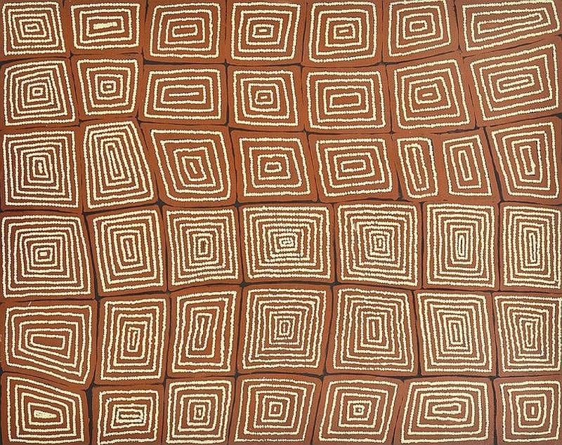 Tingari by Warlimpirrnga Tjapaltjarri, 2002. A large horizontal painting in warm reddish-brown and cream. The surface is divided into dozens of irregular rectangular blocks arranged like a mosaic. Inside each block, fine cream dotted lines spiral inward to form rectangular labyrinths of varying sizes and orientations. The repeating geometric patterns create a rhythmic aerial view of interconnected ceremonial places across the Western Desert.
