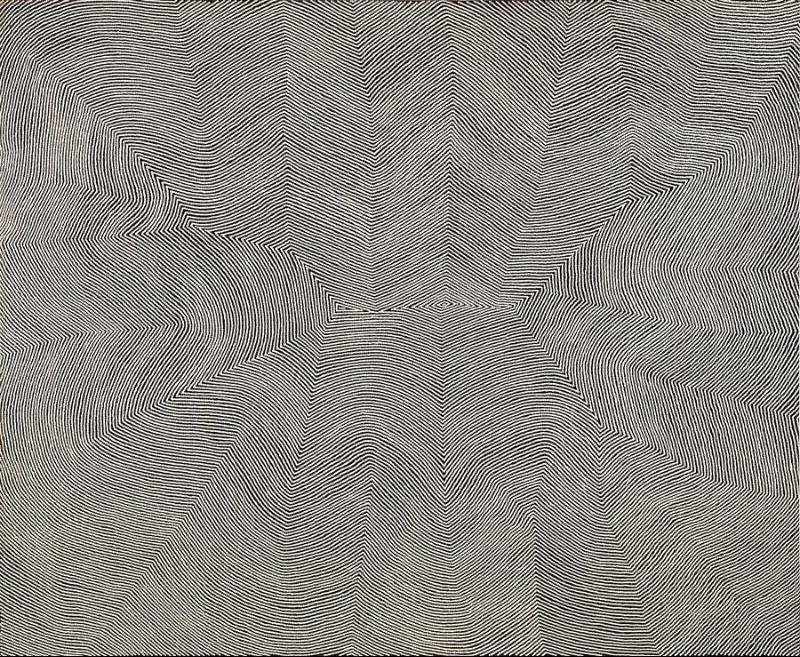 Wilkinkarra (Lake Mackay) by Warlimpirrnga Tjapaltjarri, 2017. Monumental black and white Aboriginal painting composed of thousands of meticulously painted parallel lines that radiate from a small central motif into broad triangular and curving forms. The uninterrupted linework creates powerful optical movement, evoking aerial views of desert sandhills, ancestral pathways and the vast landscape surrounding Lake Mackay.