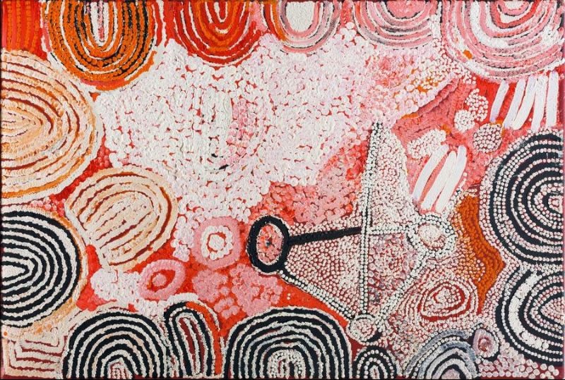Naata Nungurrayi painting Untitled (Rockhole and Soakage Water Site of Ngaminya) (2001), featuring sweeping sandhill motifs in black, white and ochre surrounding ceremonial forms on a vibrant pink and red background.