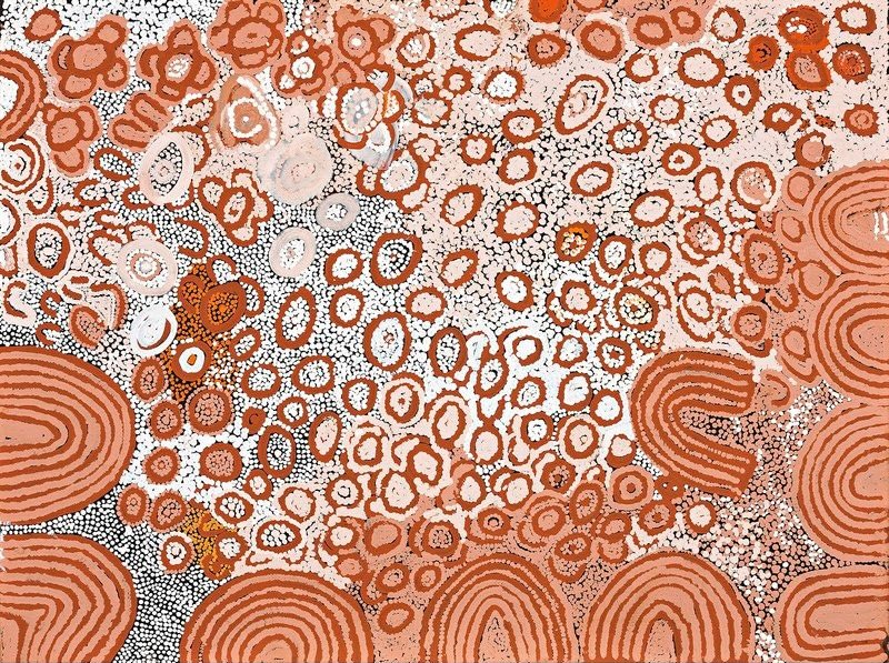 Naata Nungurrayi painting Marrapinti (2002), featuring sweeping sandhill motifs framing hundreds of concentric ceremonial forms in soft pink, terracotta, white and ochre on a luminous desert ground.