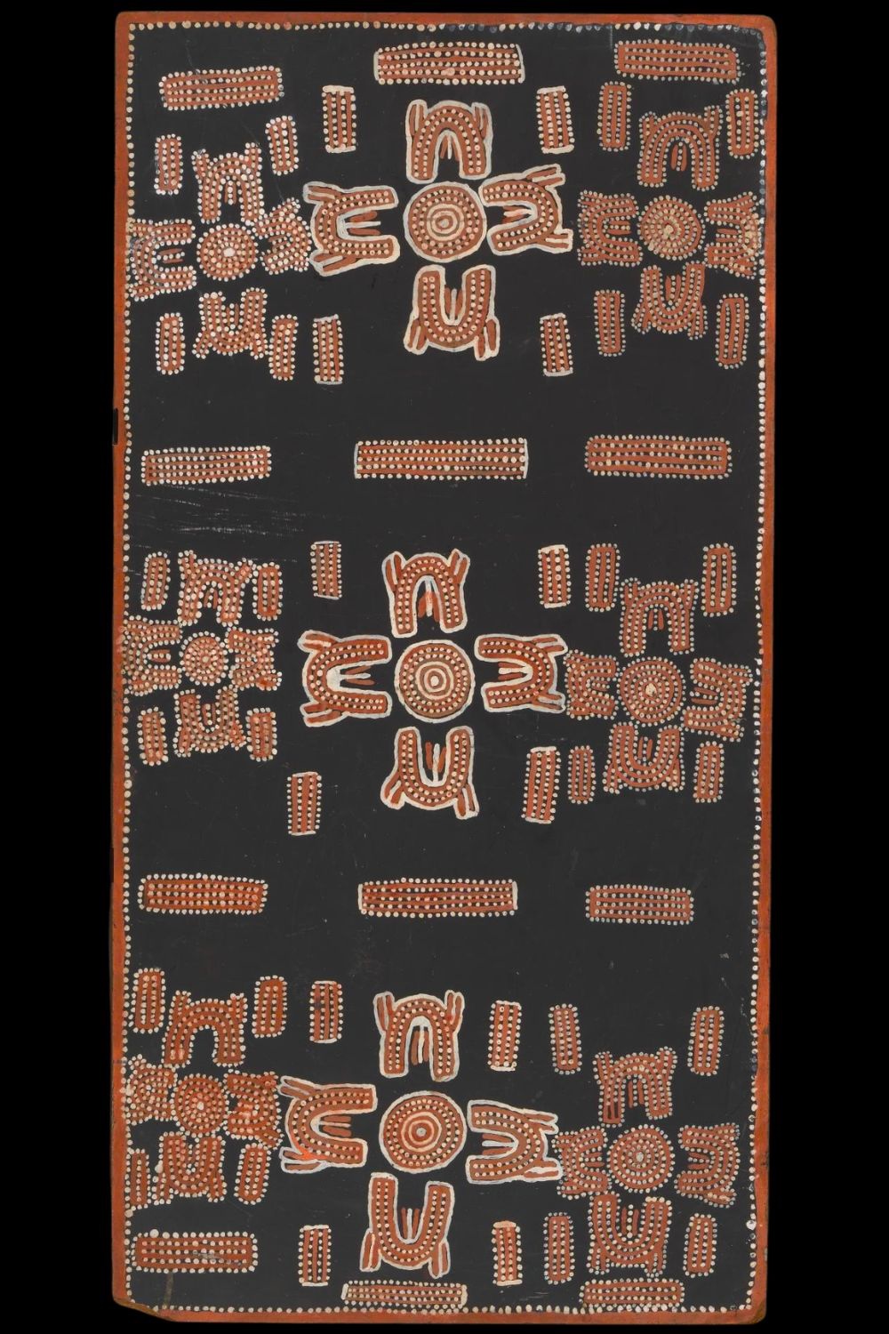 Early Papunya Board by Don Ellis Tjapanangka, c.1972, with concentric circles, U-shaped figures and parallel bar motifs painted in ochre, white and black.