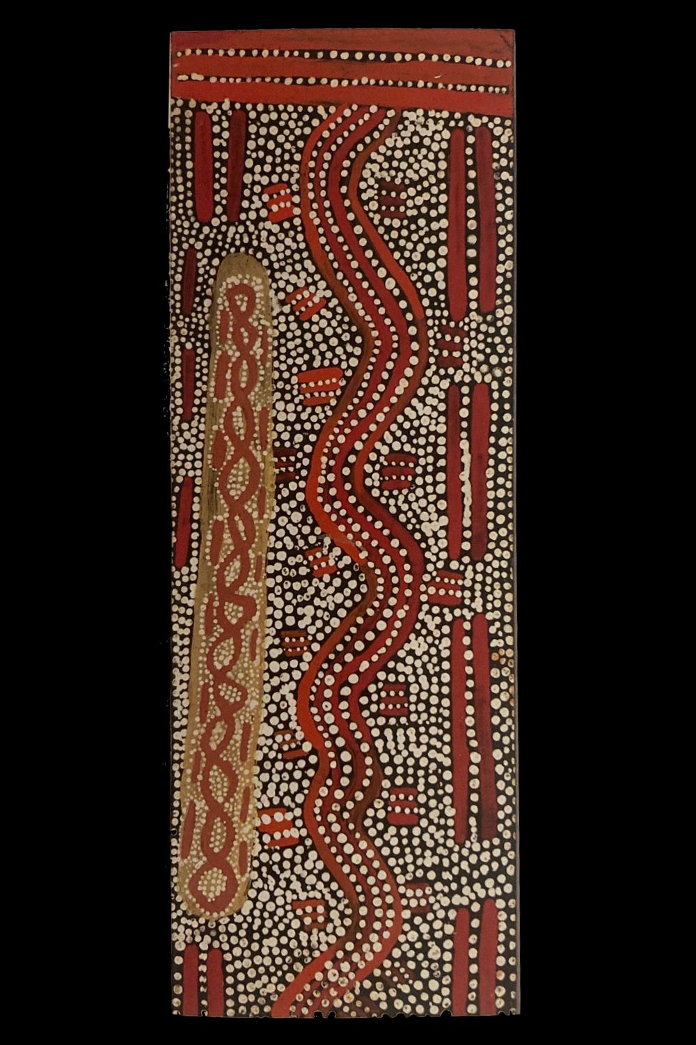 Early Papunya Board by Kingsley Tjungurrayi featuring a central Tingari pathway with flowing parallel lines, white dot infill and ochre geometric motifs.