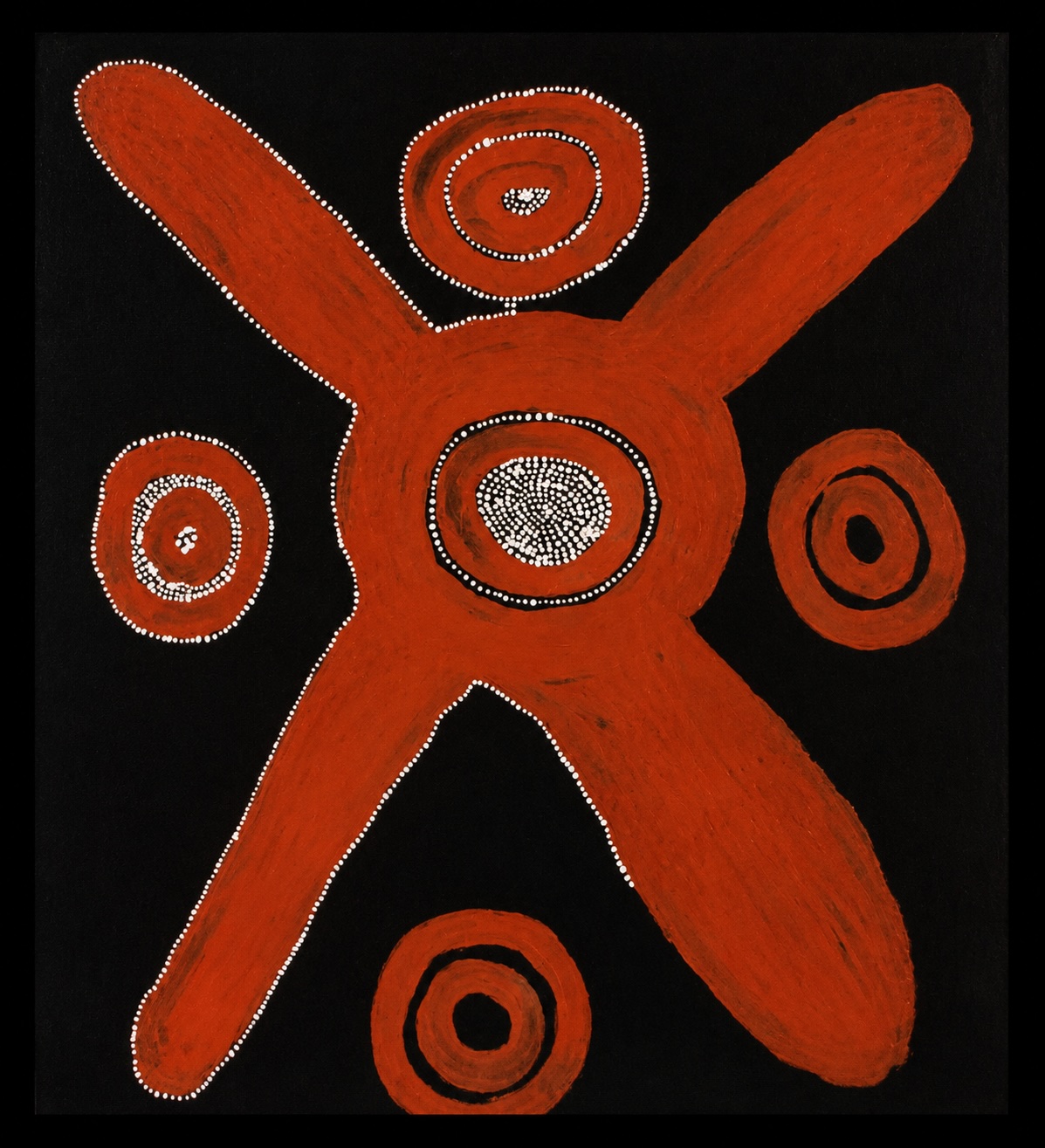 Early Papunya Board by Tommy Lowry Tjapaltjarri featuring a bold central ceremonial form surrounded by concentric circles on a black background.