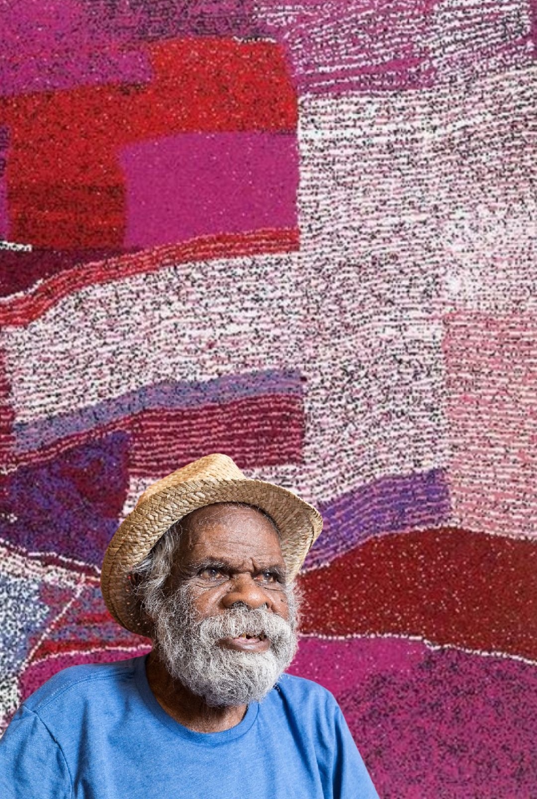 Tommy Watson – Aboriginal Artist of the Western Desert Portrait of Aboriginal artist Tommy Watson in front of one of his vibrant abstract Western Desert paintings inspired by his ancestral Pitjantjatjara Country.