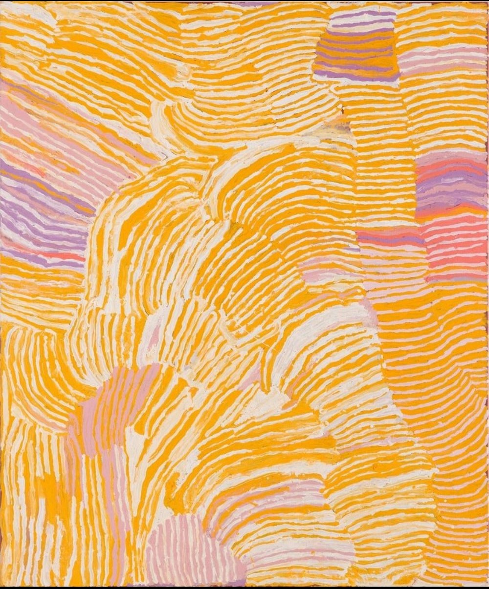 Lupulnga (2003) by Makinti Napanangka, featuring sweeping bands of yellow, white and mauve inspired by Pintupi women's ceremony and ceremonial hair-string skirts.