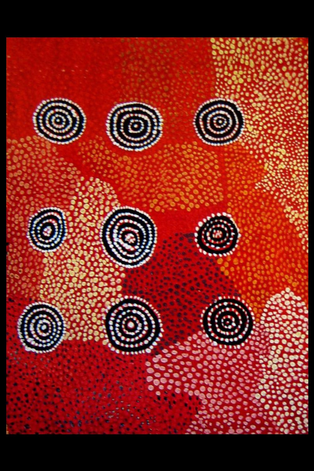 Untitled painting by Nosepeg Tjupurrula depicting concentric ceremonial sites across Lake Mackay Country using red, black, white and ochre dot work.