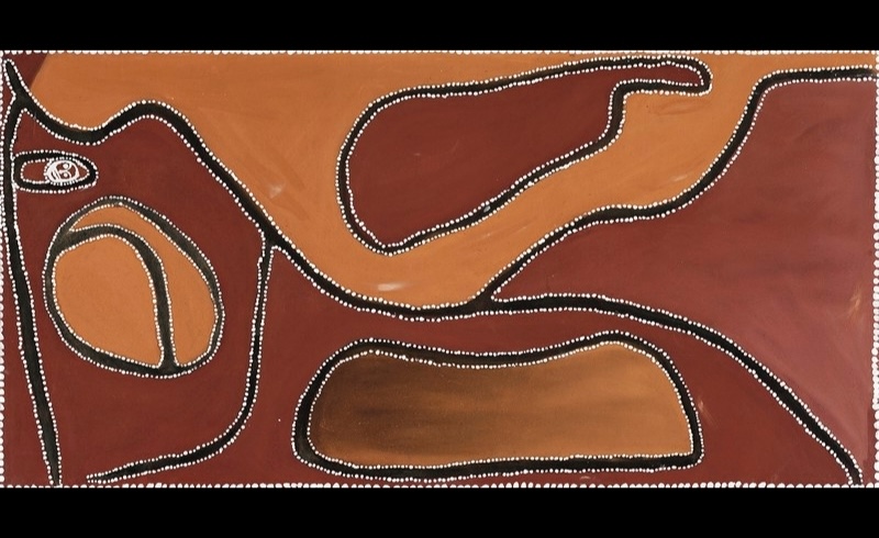 Rover Thomas ochre painting with large red-brown areas, black winding pathways and enclosed oval forms, all bordered by fine rows of white dots.