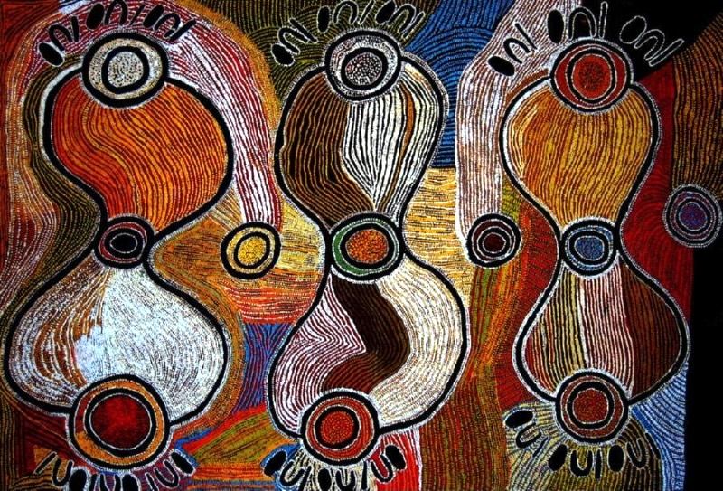 Maggie Watson Napangardi painting with three large hourglass-shaped forms outlined in black and white, linked by concentric circles and surrounded by flowing fields of red, orange, yellow, blue, brown and white lines.