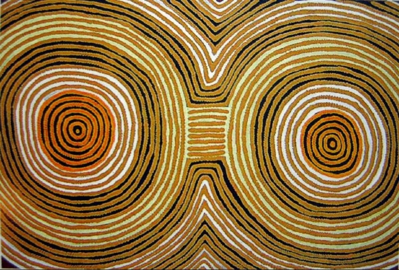 Ronnie Tjampitjinpa’s Tingari Cycle (1997), featuring two large concentric circular forms joined at the centre and surrounded by rhythmic bands of black, white, ochre, orange and pale green.