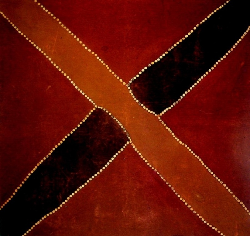 Rover Thomas ochre painting showing two diagonal roads crossing at the centre, one brown and one black, edged with rows of pale dots on a deep red ground.