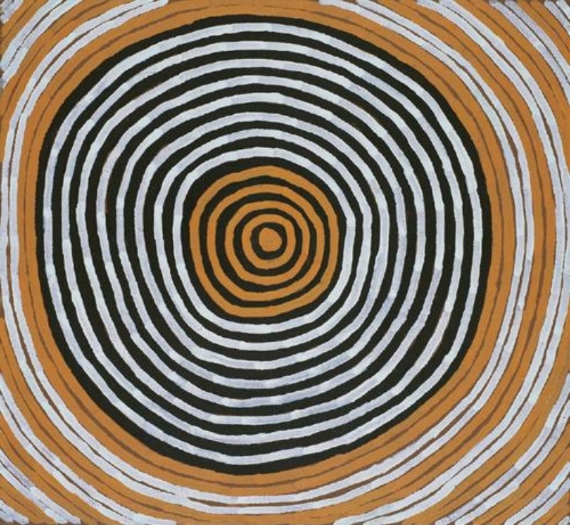 Ronnie Tjampitjinpa Moon Dreaming 1999 painting, featuring a large circular design of concentric black, white and ochre rings radiating from a central circle.