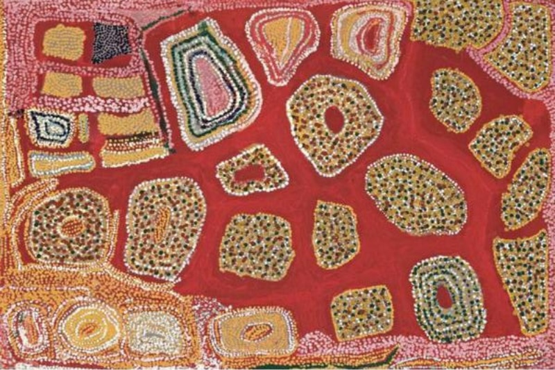 Wimmitji Tjapangarti's Pilyarpa, North of Jupiter Well, 1992, with irregular dotted sites and concentric forms arranged across a broad red field bordered by pink, ochre, white and green patterns.