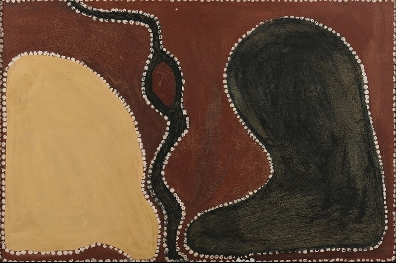 Rover Thomas ochre painting with large yellow and black rounded forms separated by a winding black snake-like line, outlined with white dots on a red-brown ground.